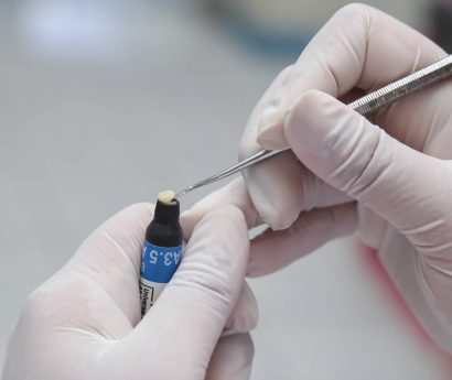 dental technician working with materials for restorative treatment