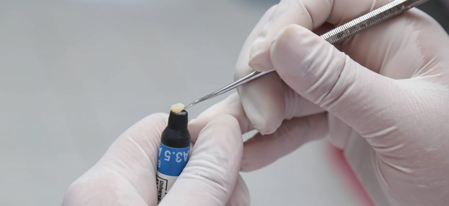 dental technician working with materials for restorative treatment