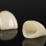 isolated dental crowns on a black background