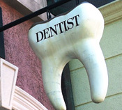 tooth-shaped hanging dentist sign