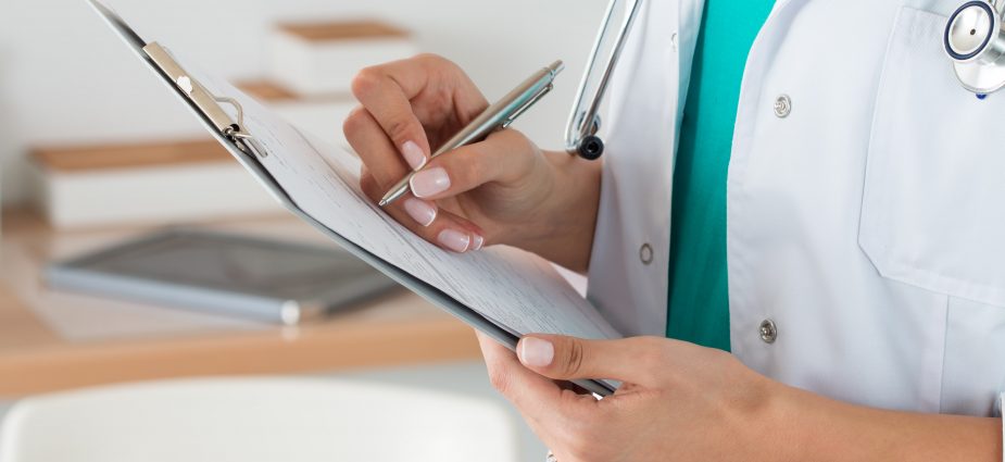 dentist taking notes after seeing patient