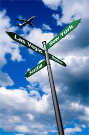 airplane flying over street signs for cities