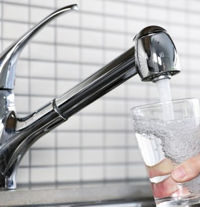 filling a glass of water from kitchen faucet