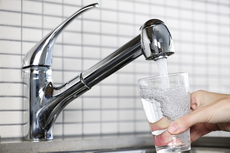 filling a glass of water from kitchen faucet